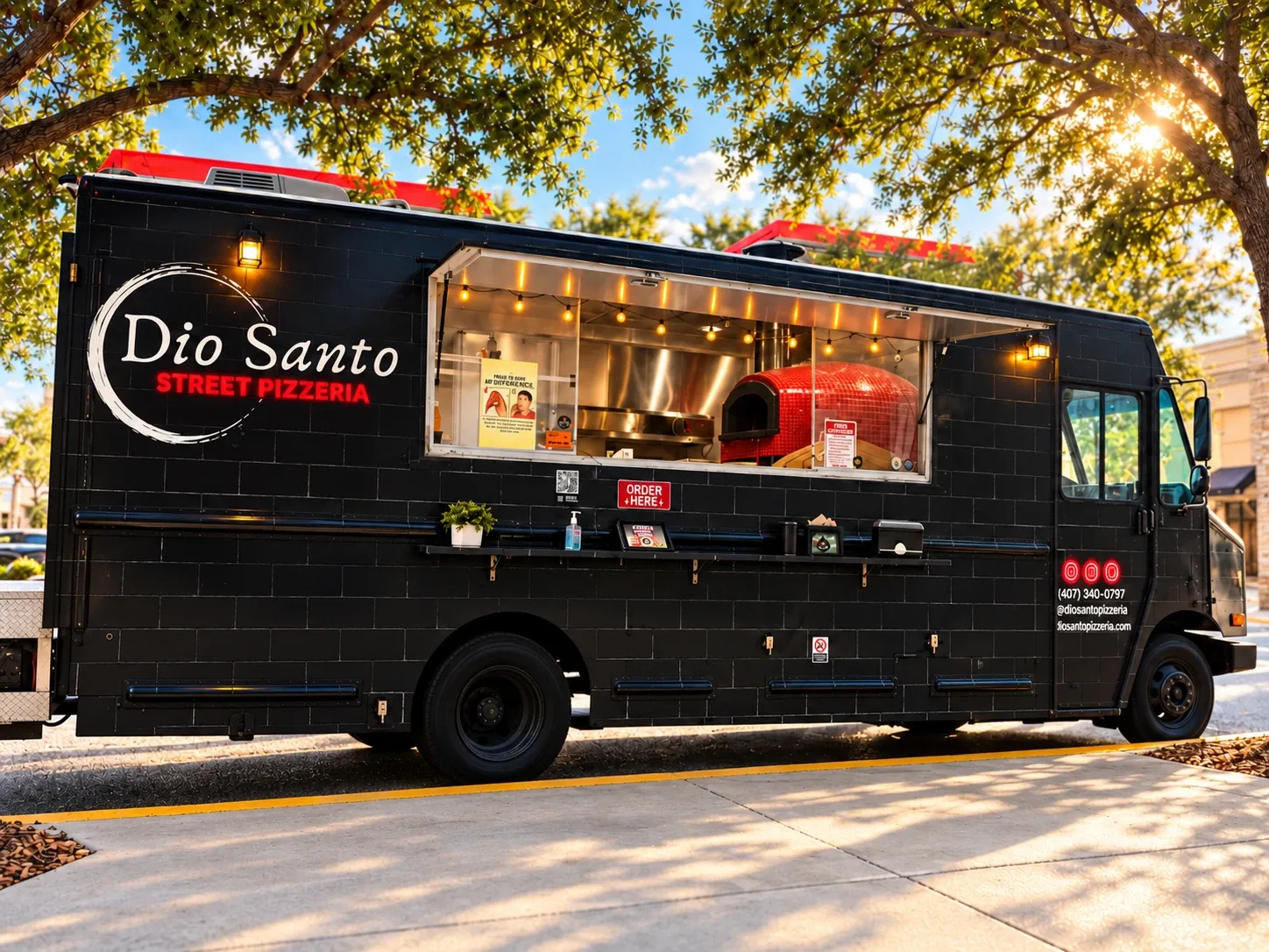 The Dio Santo Street Pizzeria food truck parked under trees